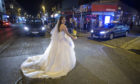 Bride Rowan races for her taxi to beat the curfew in Glasgow’s West End on Friday