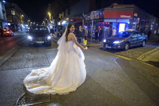 Bride Rowan races for her taxi to beat the curfew in Glasgow’s West End on Friday