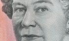 A close-up of the Queen on an Australian five dollar bill