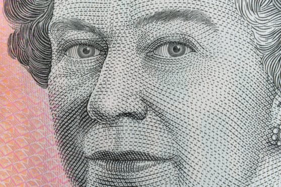 A close-up of the Queen on an Australian five dollar bill