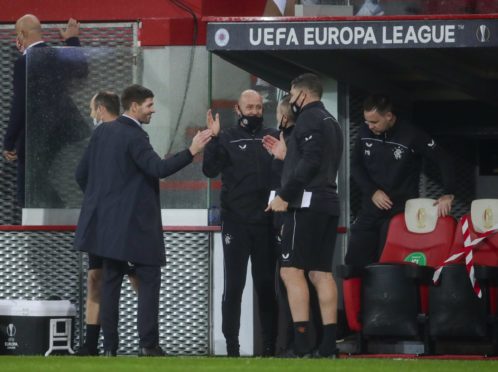 Steven Gerrard and his backroom team enjoy the win in Liege, which was rounded off by Kemar Roofe’s brilliant goal