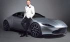 Daniel Craig with an Aston Martin DB10 as James Bond.