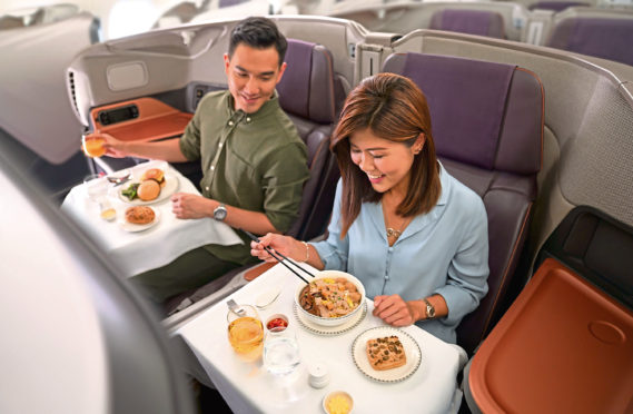 A couple sit down to their in-flight meal on board an A380 Airbus – but they’re going nowhere.