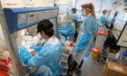 Scientists working at the Lighthouse Laboratory at the Queen Elizabeth University Hospital in Glasgow