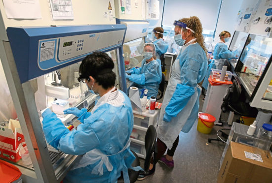 Scientists working at the Lighthouse Laboratory at the Queen Elizabeth University Hospital in Glasgow