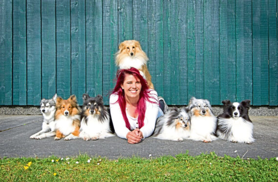 Kaylee Garrick poses with her canine friends