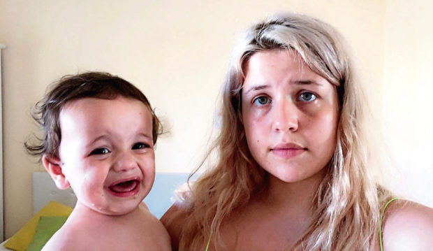 Leigha Collins with baby Hayes in a one-room hostel in Malta
