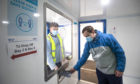 Andrew Ilesley collects a self-test kit during a  demonstration on how to use the new walk-through Covid testing centre in Dundee