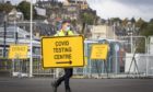 Jim Connell sets up signs at a new walk-through Covid test centre at The Engine Shed, Stirling, which opened to the public this weekend