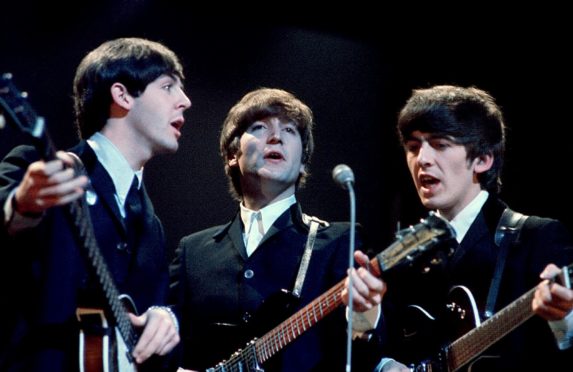 Paul, John, and George return to the London Palladium in 1964 after their landmark performance the year before