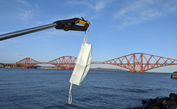 A surgical mask found during a litter cleanup near the Forth Bridge