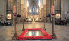 The Grave of the Unknown Warrior inside Westminster Abbey has four candles placed at each of the four corners during Remembrance.