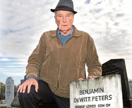 Gordon Peters at the grave of his son, Benjamin at the Hoop Lane Cemetery in London.