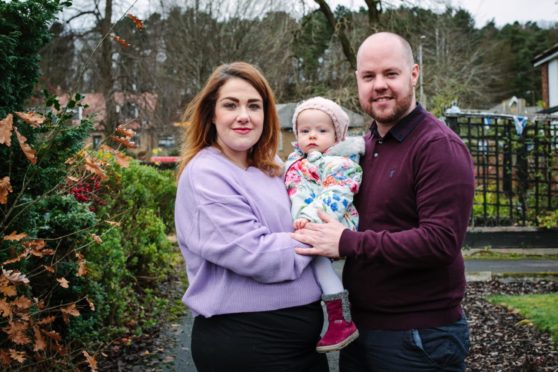 Mum Jamie Cameron, with husband Stephen Holton, and their baby daughter Alba.