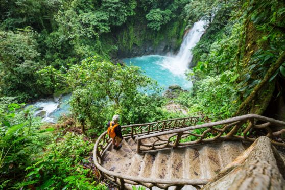 Majestic waterfall in the rainforest jungle of Costa Rica. Tropical hike.; Shutterstock ID 1007072176; Purchase Order: Sunday Post; Job: Sunday Post