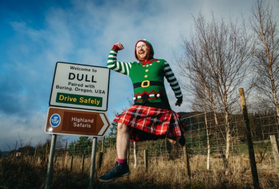 Jamie Pringle shows off the special tartan he created to mark the tie-up between Dull and Boring