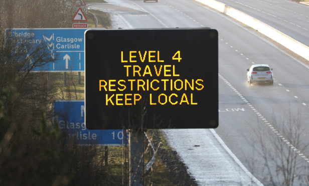 A traffic information board as traffic flows on the M80 near Banknock, Scotland