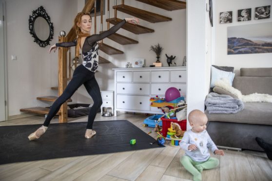 Ballet star Iana Salenko, with son William, works out at home in Berlin, Germany.