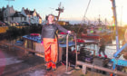 Elaine Black alongside her trawler, the Kinloch, which is tied up at Pittenweem, Fife