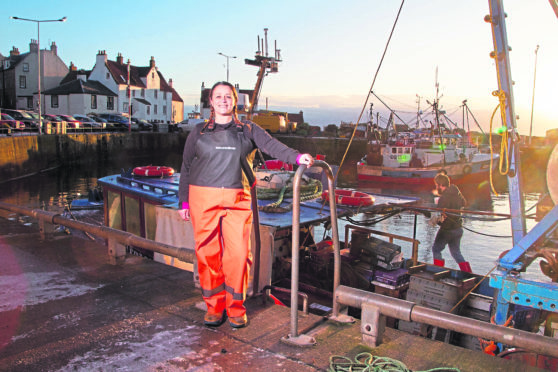 Elaine Black alongside her trawler, the Kinloch, which is tied up at Pittenweem, Fife