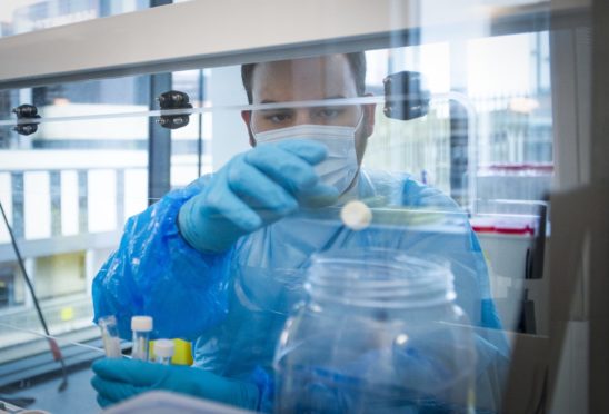 A scientist prepares a sample for Covid-19 testing at Glasgow Lighthouse facility