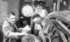 Frank Whittle, left, and colleagues work on first jet engine