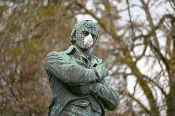 A statue of Scotland's national bard Robert Burns wearing a mask during the Coronavirus pandemic.