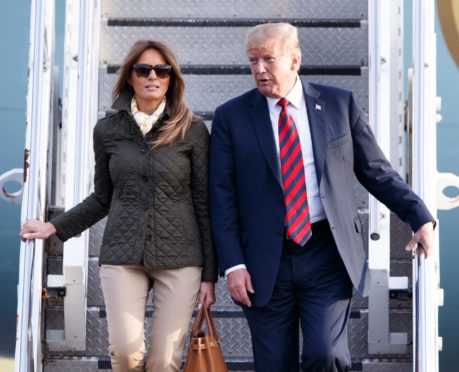 Donald and Melania Trump disembark Air Force One during their 2018 trip to the UK