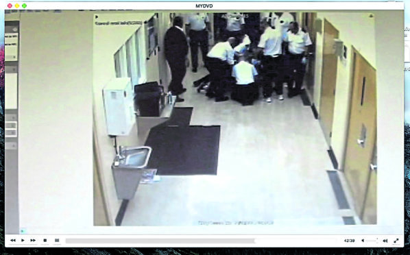 CCTV footage stills, of camera 331
, showing Allan Marshall being restrained by prison officers - he later died from his injuries.