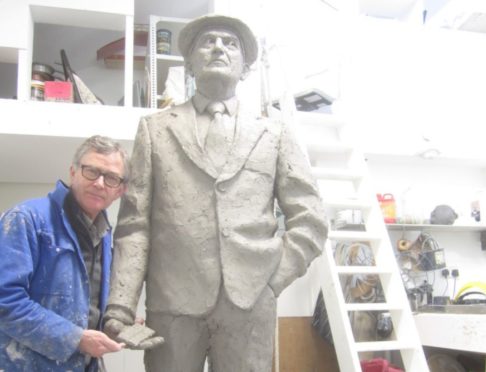 Sculptor David Annand with his statue of Chic Murray.