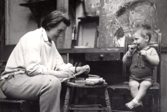 Joan Eardley sketching a little boy in her studio in Townhead, Glasgow