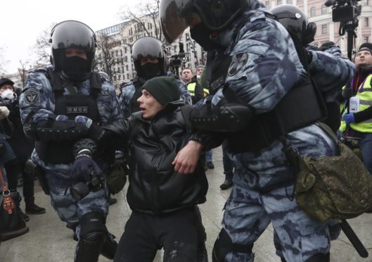 Police detain a man during a protest against the jailing of opposition leader Alexei Navalny in Moscow, Russia, Saturday, Jan. 23, 2021.