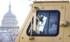 A National Guard soldier sits in a military vehicle near the US Capitol building in Washington DC as security tightens ahead of Wednesday’s inauguration of Joe Biden