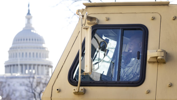 A National Guard soldier sits in a military vehicle near the US Capitol building in Washington DC as security tightens ahead of Wednesday’s inauguration of Joe Biden