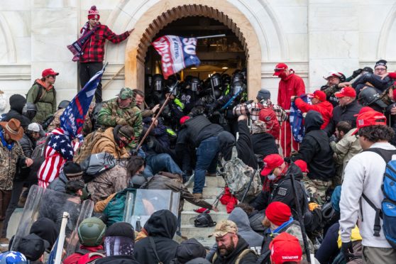 Rioters clash with police trying to enter Capitol building through the front doors