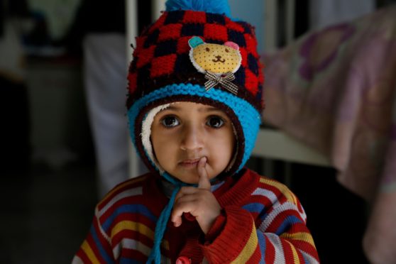 A Yemeni girl looks on as her brother is treated for malnutrition at a Sana’a hospital in January.