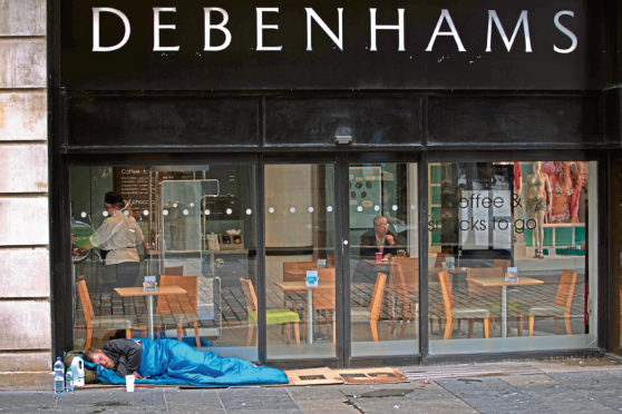 A homeless person outside a coffee shop in Glasgow.