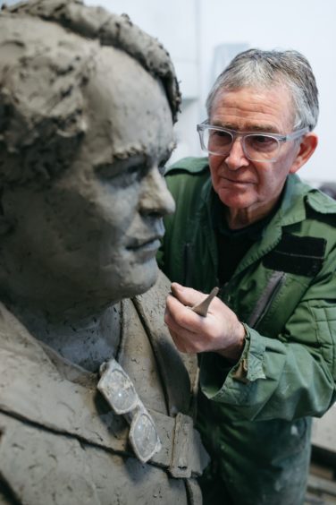 David working on the statue