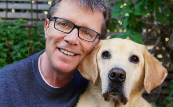 Nicky Campbell with Labrador Maxwell who helped the TV and radio presenter deal with his feelings of abandonment