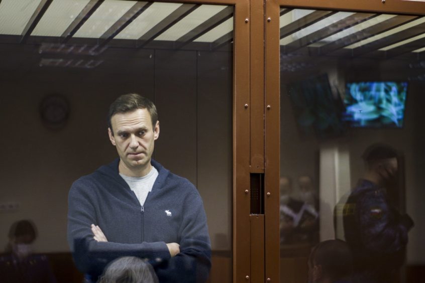 Russian opposition leader Alexei Navalny stands during a hearing on charges of defamation