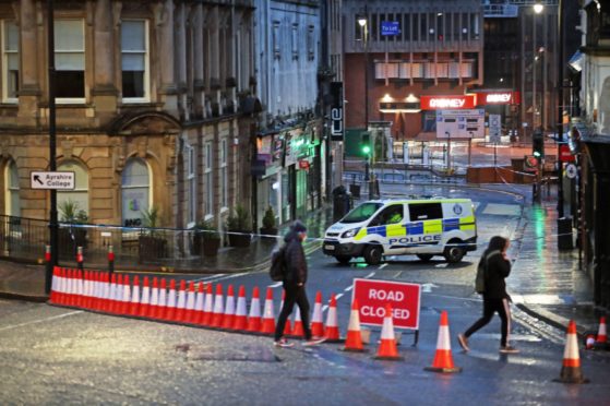 A police cordon at West George Street in Kilmarnock, where officers continue to investigate what Police Scotland describe as a "serious incident" in the grounds of a local hospital and another location in the area.