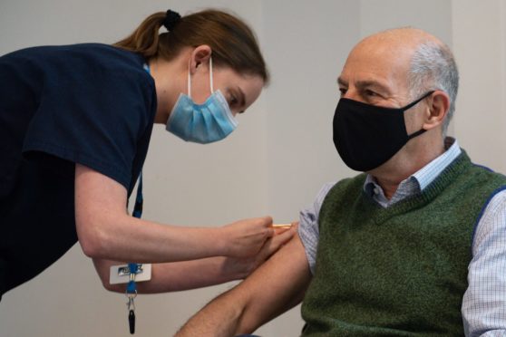 Broadcaster and author Loyd Grossman, 70, receives an injection of the Oxford AstraZeneca Covid-19 vaccine.