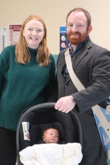 Caroline Hutchison, husband Pete and baby Fraser leaving hospital
