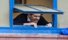 Rangers manager Steven Gerrard looks out of the dressing room window to fans gathered outside Ibrox