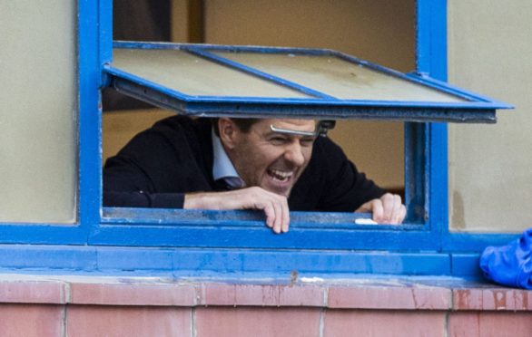 Rangers manager Steven Gerrard looks out of the dressing room window to fans gathered outside Ibrox