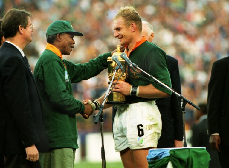 One nation: President Nelson Mandela congratulates captain François Pienaar after South Africa win the Rugby World Cup in June 1995. A symbolic moment of unity after the recent end of apartheid.