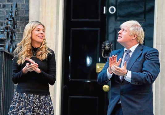 Boris Johnson taking part in the Clap for our Carers with his partner Carrie Symonds.