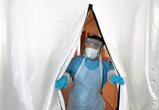 A technician at the testing lab at Queen Elizabeth University Hospital, Glasgow in April 2020