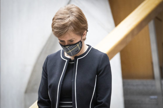 First Minister Nicola Sturgeon observes a minute's silence during the National Day of Reflection