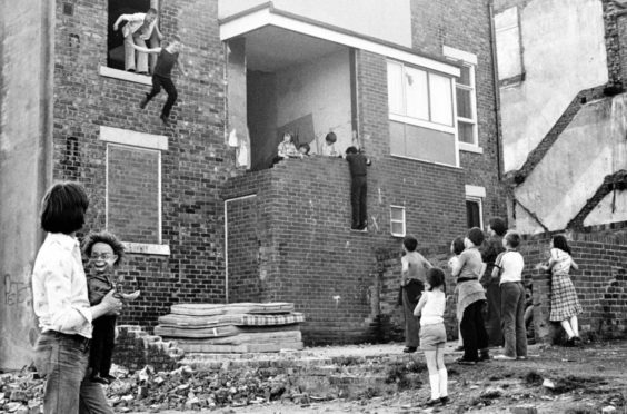 Children in Newcastle upon Tyne’s West End gather and play on piled-up mattresses in an image from Tish Murtha’s 1981 seminal photo-essay Youth Unemployment